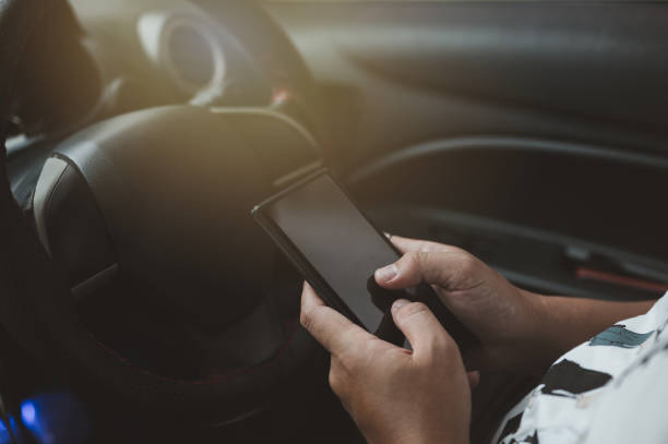 istock Young man driving car and using mobile phone 1399161677