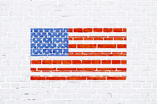Vector illustration of painted USA flag on a horizontal vector  brick wall. Apt for use as wallpapers, posters, backdrops, banners, greeting cards templates or patriotic t shirt designs for US Independence Day, 4th of July or Memorial Day. There is No people and no text and ample copy space.