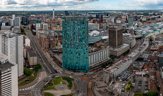 Birmingham, UK - May 24, 2022.  An aerial view of Birmingham city centre with The Radisson Blu Hotel skyscraper, New Street Train Station and The Bullring shopping Mall