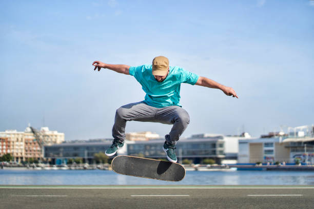 Man doing a cool skateboard move in town