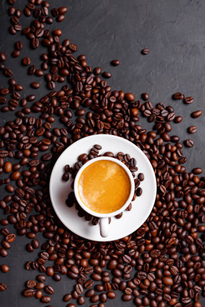 istock Hot fresh black coffee with milk foam for morning menu in white ceramic cup with coffee beans roasted on. 1399166119