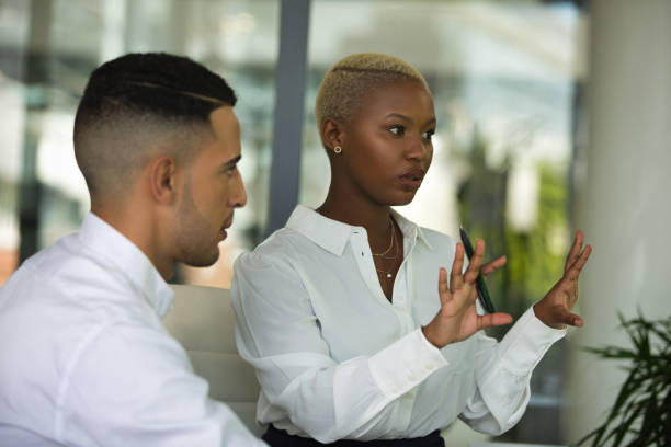 istock Young colleagues sitting by heir desk 1399166483