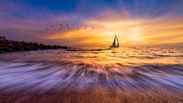 istock Sunset Sailboat Ocean Landscape Sun Ray Birds 1399167622