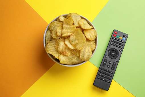 Remote Chips Modern Tv Remote Control And Chips On Color Background Flat Lay Stock ...