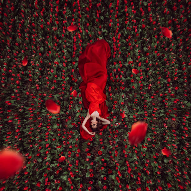 istock Beautiful woman in tulips field 1399171045