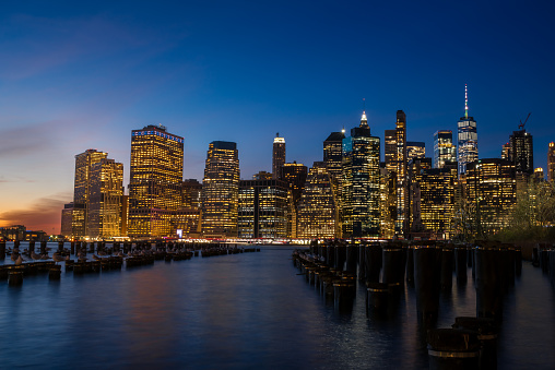 New York from Brooklyn at sunset with dark sky and buildings with lights on