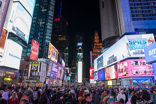 Manhattan, New York City, USA - December 24, 2019: Times Square, iconic street in Manhattan full of tourists on a night in Christmas days