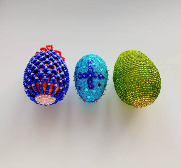 Handmade Easter Eggs made of beads on a white background. copy space.