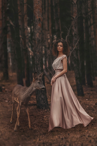 Beautiful woman with deer photoshoot