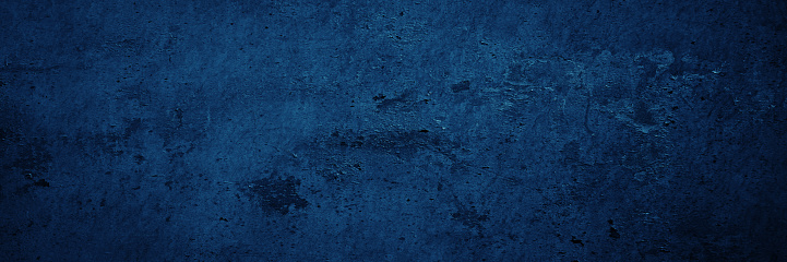 Blue grunge texture. Toned rough wall surface. Background with space for design. Web banner. Wide. Panoramic.