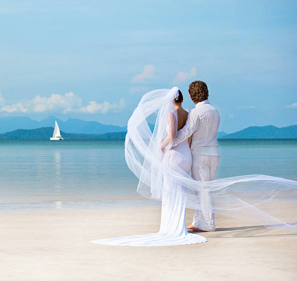 Close-up of couple photographing for wedding at beach stock photo