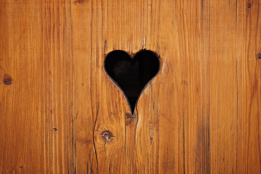 Heart shape in light brown wood plank. Alsace traditional decoration