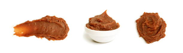 Miso Paste Isolated Miso paste isolated. Japanese seasoning, fermented soybean spread, puree for soup, brown soy cream for japan broth, miso paste on white background miso sauce stock pictures, royalty-free photos & images