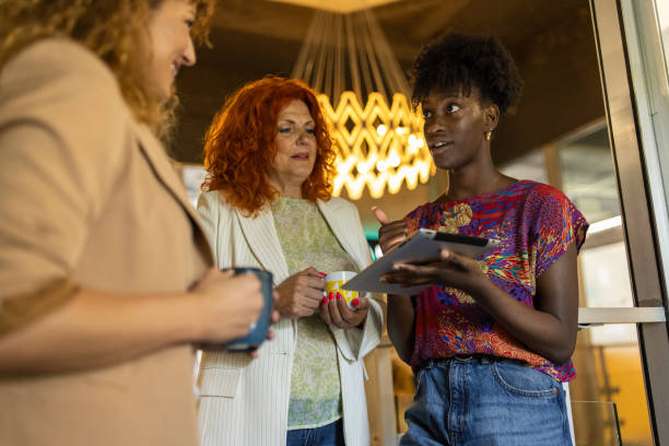 istock Group of multiracial female colleagues working together while using digital tablet 1399175751