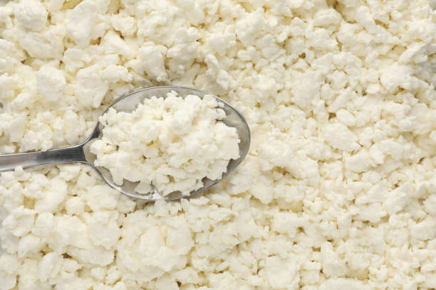 istock Delicious fresh cottage cheese and spoon as background, top view 1399176951