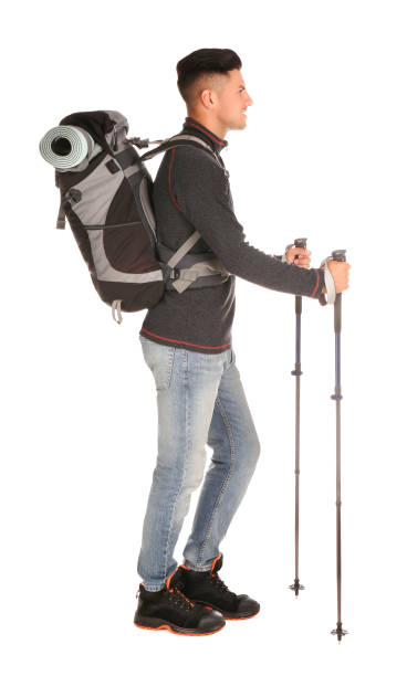 istock Male hiker with backpack and trekking poles on white background 1399176964