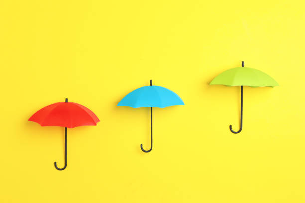 istock Bright toy umbrellas on yellow background, flat lay 1399177031