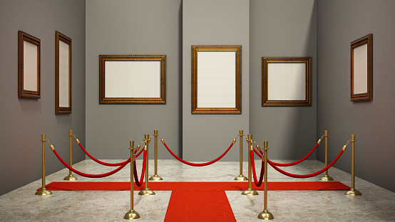 Blank golden picture frames on the walls of an art gallery.