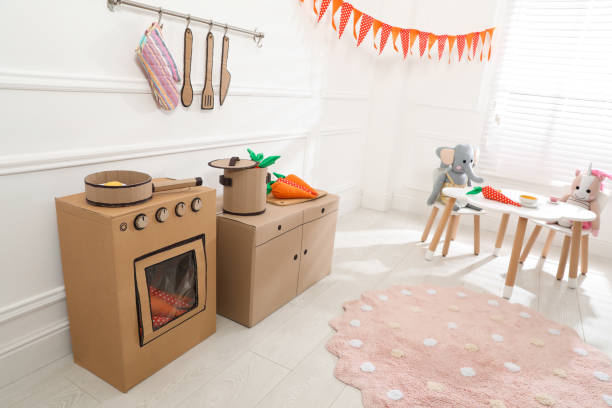 istock Toy cardboard kitchen with stove and utensils at home 1399177745