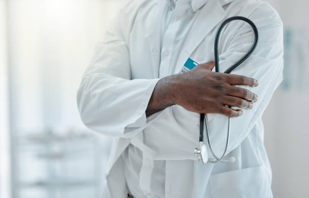 istock Proud doctor standing with their arms crossed and holding a stethoscope while working at a hospital alone. One expert medical professional standing while at work at a clinic 1399178512