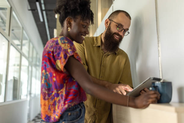 istock Modern multiracial female and male colleagues using digital tablet 1399178528