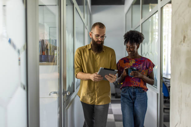 istock Multiracial female and male colleagues using digital tablet 1399178537