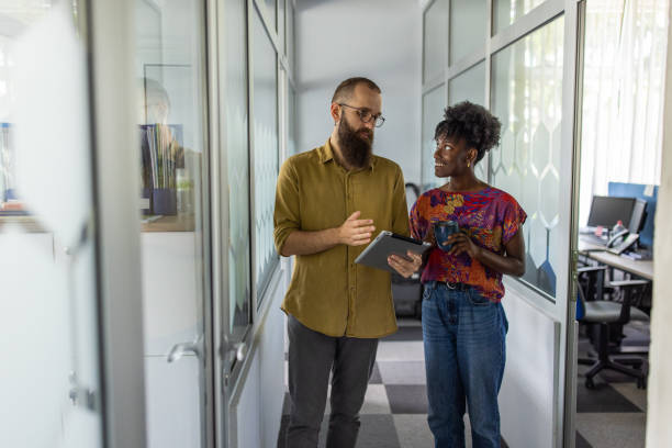 istock Multiracial female and male colleagues using digital tablet 1399178611