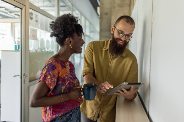istock Modern multiracial female and male colleagues using digital tablet 1399178908