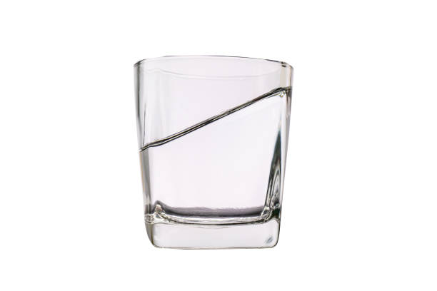 istock glass for liquor Translucent elements made of glass tilted empty objects isolated on a white background. 1399179325