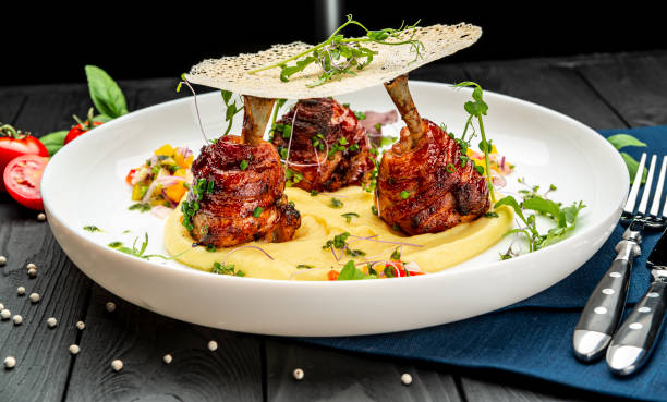 istock Chicken legs wrapped in bacon with barbecue sauce on mashed potatoes 1399179428