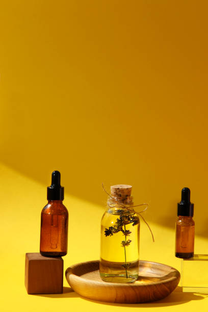 istock Face serum and lavender spa oil on podium on yellow background 1399181510
