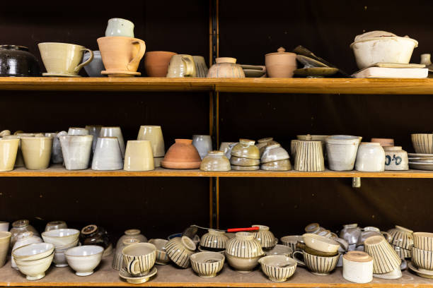 Many types of ceramics sitting on shelves.