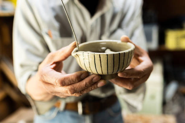 Close up of potter shaping clay cup in studio