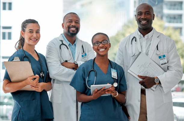 istock Group of doctors and nurses standing in a line with their arms crossed while working at a hospital. Content expert medical professionals smiling at work together at a clinic 1399183002