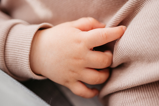 Close-up of a newborn baby boy's hand.
