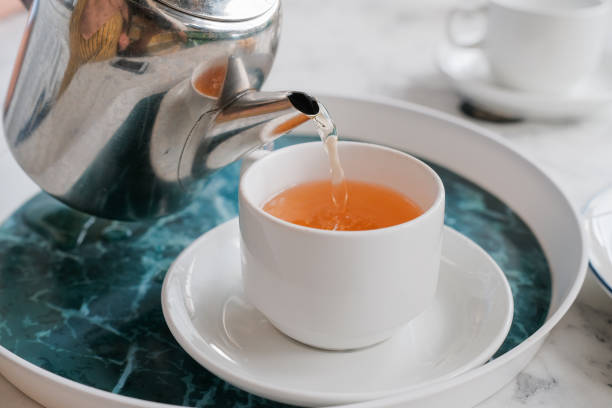 istock Pouring tea into cup of tea. 1399186606