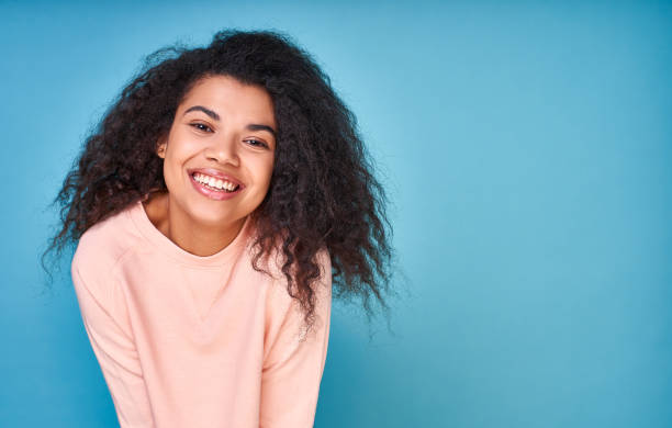 istock A happy optimistic curly ethnic girl smiles. 1399188486