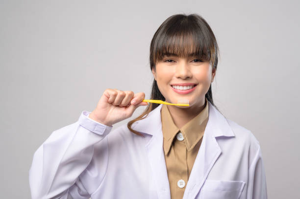 istock Young female dentist smiling over white background studio 1399188740
