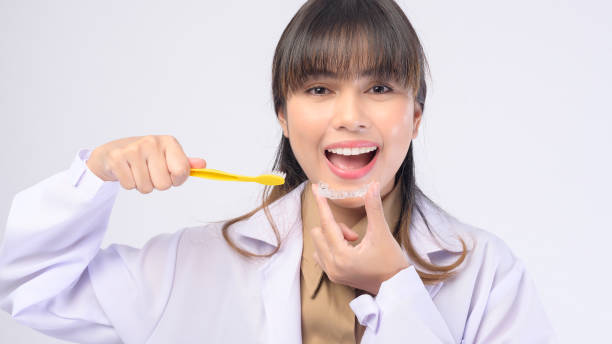 istock Young female dentist smiling over white background studio 1399188779