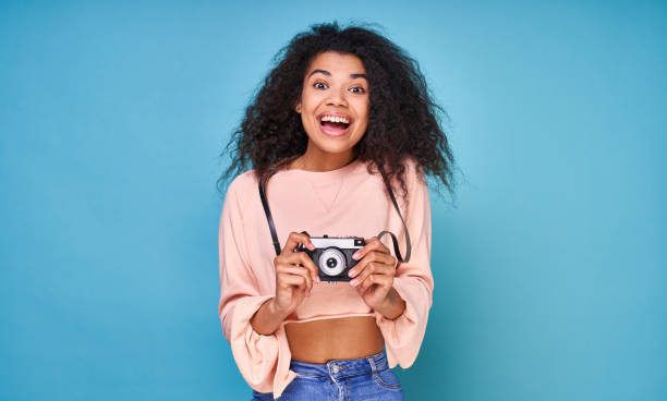 istock Charming happy lady with a retro camera in hand. 1399191617