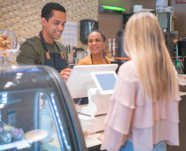 istock Female customer paying order at coffee shop register 1399192368