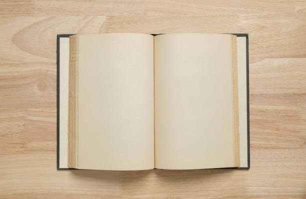 istock open old book on wooden table for mockup blank template 1399193112