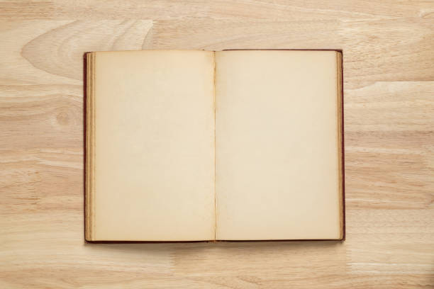 istock open old book on wooden table for mockup blank template 1399193150