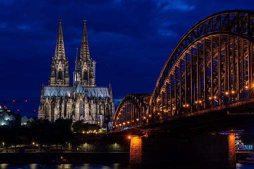 COLOGNE, GERMANY, 23 JULY 2020: Night view of Cologne Cathedral and Hohenzollern Bridge