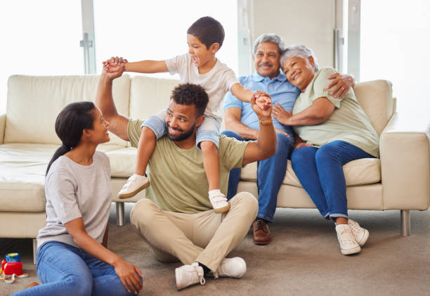 istock A mixed race family bonding together while parents playing with the kids while the grandparents relax on the couch at home 1399195057