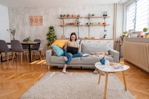 istock Young Mother Checking Her Finances While Her Baby Is Asleep 1399195496