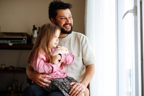 istock Young father and cute little girl with white rabbit 1399196247