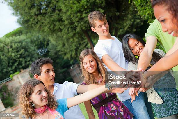 Happy Teenage Group With Hands On Stack Stock Photo - Download Image Now - 18-19 Years, Achievement, Adolescence