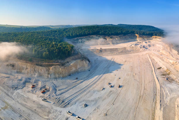 istock Aerial view of open pit mining of limestone materials for construction industry with excavators and dump trucks. 1399197037