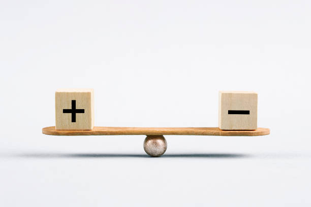 Seesaw and cubes with plus and minus sign